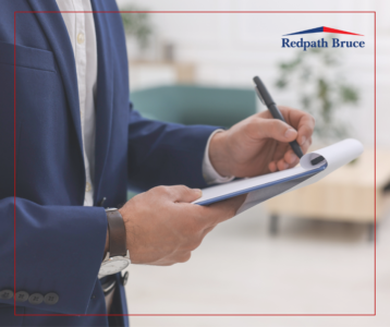 Image shows a masculine profile in a suit holding a clipboard writing something down.
